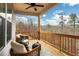 Inviting covered deck with outdoor seating, ceiling fan, and scenic wooded view; perfect for relaxing at 159 Sunshower Rdg, Canton, GA 30114
