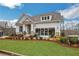 Charming home featuring stone accents, a covered front porch, and professional landscaping at 159 Sunshower Rdg, Canton, GA 30114