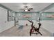 Home gym featuring mirrors, yoga mat, stationary bike, and light blue walls for a serene workout space at 159 Sunshower Rdg, Canton, GA 30114