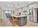 Spacious eat-in kitchen features stainless appliances, large center island, and modern pendant lighting at 159 Sunshower Rdg, Canton, GA 30114