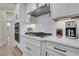 Chef's kitchen features white cabinets, quartz countertops, stainless appliances, and gas cooktop at 159 Sunshower Rdg, Canton, GA 30114