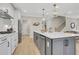 Modern kitchen with gray island, stainless appliances, white cabinets and counters, and open layout at 159 Sunshower Rdg, Canton, GA 30114