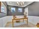 Bright office space with wainscoting, neutral tones, wood desk and floors, and modern light fixture at 159 Sunshower Rdg, Canton, GA 30114