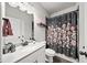Bathroom featuring a black floral shower curtain, white vanity, and modern fixtures at 191 Madison Bnd, Woodstock, GA 30188