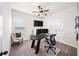 Bedroom featuring an office setup, ceiling fan, and neutral-toned walls at 191 Madison Bnd, Woodstock, GA 30188