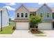 Charming townhome featuring a two-car garage and well-maintained landscaping at 191 Madison Bnd, Woodstock, GA 30188