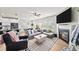 Comfortable living room with fireplace, open to dining and kitchen at 191 Madison Bnd, Woodstock, GA 30188