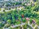 Aerial view of a suburban neighborhood featuring tree-lined streets and well-maintained homes at 241 Tweed Ct, Sugar Hill, GA 30518
