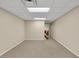 Open basement space with tan walls and neutral carpet at 241 Tweed Ct, Sugar Hill, GA 30518