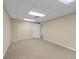 Finished basement area featuring neutral walls and carpet at 241 Tweed Ct, Sugar Hill, GA 30518