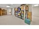 Unfinished basement with neutral carpet, storage shelving, and access to another room at 241 Tweed Ct, Sugar Hill, GA 30518