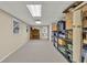 Unfinished basement space with neutral carpet, storage shelving, and a small window at 241 Tweed Ct, Sugar Hill, GA 30518