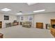 Unfinished basement area featuring neutral carpet, two windows, a loveseat, and wooden furniture at 241 Tweed Ct, Sugar Hill, GA 30518