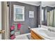 Bathroom with patterned wallpaper, large window, and modern fixtures at 241 Tweed Ct, Sugar Hill, GA 30518