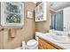 Bathroom with brown wallpaper, a single sink vanity, and lots of light at 241 Tweed Ct, Sugar Hill, GA 30518
