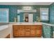 Bathroom featuring dual sinks with wooden vanity and floral wallpaper at 241 Tweed Ct, Sugar Hill, GA 30518