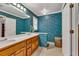 Bathroom featuring dual sinks, wooden vanity, floral wallpaper, and tiled floor at 241 Tweed Ct, Sugar Hill, GA 30518