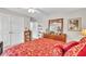 Bedroom with red bedspread and built in shelves at 241 Tweed Ct, Sugar Hill, GA 30518