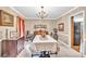 Dining room with chandelier, classic decor, and adjacent access to other rooms at 241 Tweed Ct, Sugar Hill, GA 30518