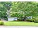 Charming single-Gathering home with lush landscaping and a well-maintained front yard at 241 Tweed Ct, Sugar Hill, GA 30518
