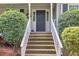 Classic front entry featuring a traditional door and well-maintained steps at 241 Tweed Ct, Sugar Hill, GA 30518