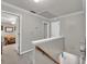 Hallway with light gray walls and access to the bedroom at 241 Tweed Ct, Sugar Hill, GA 30518