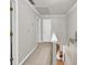 Hallway with light gray walls and hardwood floors at 241 Tweed Ct, Sugar Hill, GA 30518