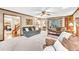 Cozy living room with plush seating, fireplace, and lots of natural light at 241 Tweed Ct, Sugar Hill, GA 30518