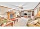 Bright living room featuring a fireplace, ceiling fan, and natural light at 241 Tweed Ct, Sugar Hill, GA 30518