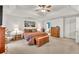 A bright main bedroom featuring neutral carpet, wooden furnishings, and white walls at 241 Tweed Ct, Sugar Hill, GA 30518