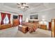 Spacious main bedroom with large bed, sitting area, and lots of natural light at 241 Tweed Ct, Sugar Hill, GA 30518