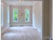 Open dining room with hardwood floors, natural light, and modern light fixture at 285 White St # 4, Marietta, GA 30060