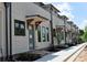 Elegant townhome exteriors showcasing brick accents, covered entrances, and well-maintained landscaping at 285 White St # 4, Marietta, GA 30060