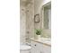 Contemporary bathroom featuring marble tiling, a granite countertop, and modern fixtures at 5029 Rosalie Rd, Johns Creek, GA 30022