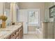Elegant bathroom with granite countertops, soaking tub, and glass-enclosed shower at 5029 Rosalie Rd, Johns Creek, GA 30022
