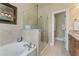 Luxurious bathroom featuring separate jetted tub and frameless glass shower at 5029 Rosalie Rd, Johns Creek, GA 30022