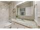Modern bathroom featuring marble tiling, granite countertop, and white vanity at 5029 Rosalie Rd, Johns Creek, GA 30022