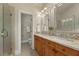 Bathroom featuring dual vanities with granite countertop and walk in glass shower at 5029 Rosalie Rd, Johns Creek, GA 30022