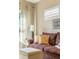 The bedroom showcases a comfortable sofa, ottoman, and a bright window at 5029 Rosalie Rd, Johns Creek, GA 30022