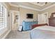 Relaxing primary bedroom with decorative crown molding and ensuite bath at 5029 Rosalie Rd, Johns Creek, GA 30022