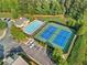 Aerial view of community amenities including a pool, clubhouse, and tennis courts at 5029 Rosalie Rd, Johns Creek, GA 30022