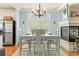 Light-filled dining room features hardwood floors, a fireplace, and a stylish chandelier at 5029 Rosalie Rd, Johns Creek, GA 30022