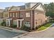 Charming brick townhome with well-manicured landscaping and inviting front entrance at 5029 Rosalie Rd, Johns Creek, GA 30022