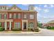 Attractive brick townhome with arched windows, shutters, and well-maintained landscaping at 5029 Rosalie Rd, Johns Creek, GA 30022