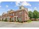 Charming brick townhome with manicured landscaping, arched windows, and inviting front entrance at 5029 Rosalie Rd, Johns Creek, GA 30022