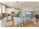 Open kitchen with island seating area overlooking the dining and living areas at 5029 Rosalie Rd, Johns Creek, GA 30022