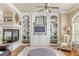 Stylish living room with custom built-in bookshelves, a fireplace, and plenty of natural light at 5029 Rosalie Rd, Johns Creek, GA 30022