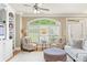 Bright living room with plantation shutters, comfortable seating, and hardwood floors at 5029 Rosalie Rd, Johns Creek, GA 30022