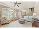 Bright and airy living room with hardwood floors, arched windows, and comfortable seating at 5029 Rosalie Rd, Johns Creek, GA 30022