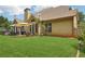 Manicured backyard with patio area and view of the house at 895 Mill Garden Pl, Cumming, GA 30040